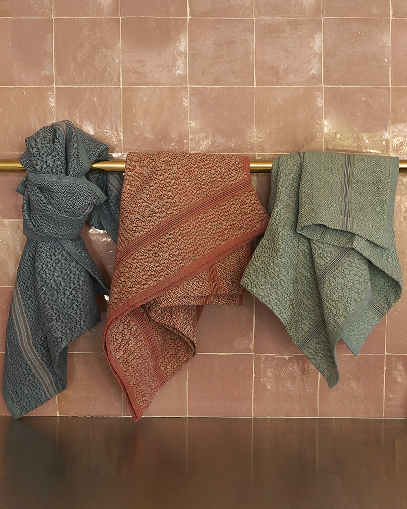 Mungo Boma Cloths hanging in a kitchen against a splash back