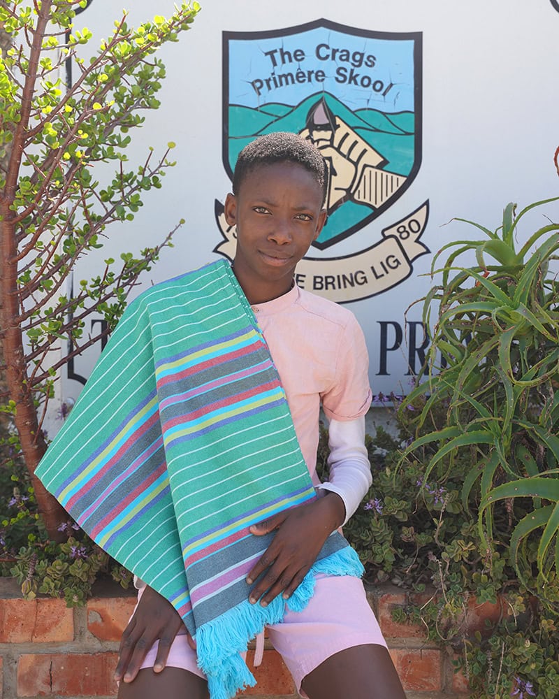 Alizwa Gigi, the Winner of the 2025 Kids of Kurland workshop, displaying his kikoi
