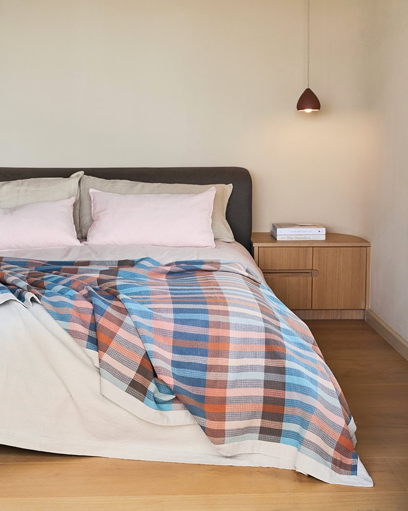 Decorative blanket styled in a bedroom setting