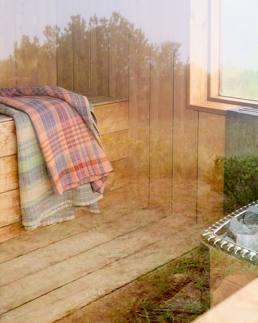 Looking through sauna window with Mungo Wayfarer towels draped on the bench.