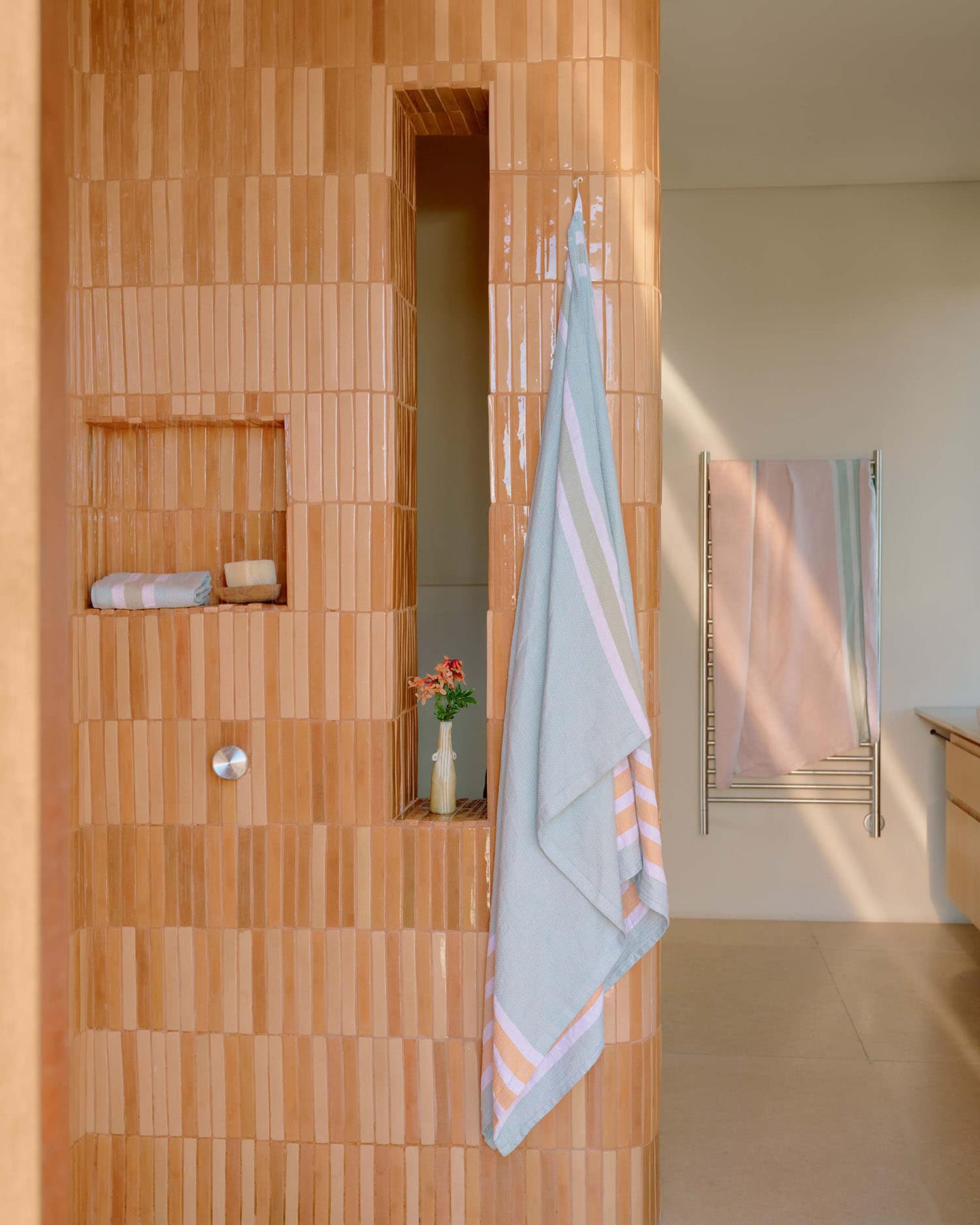 Bathroom with Mungo flax towel haning up next to shower.