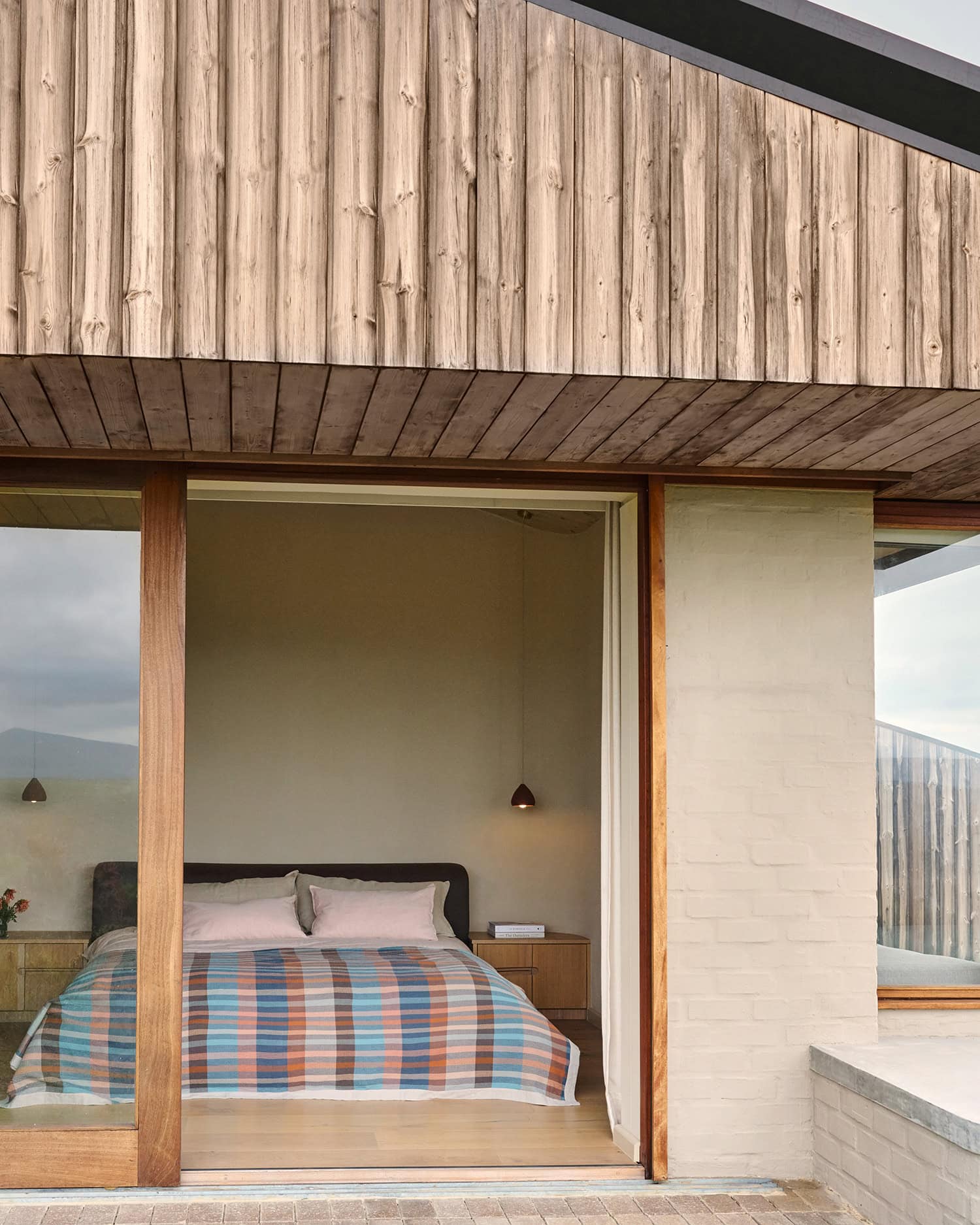 View of a bedroom with a Mungo Duo blanket in Mesa on the bed.