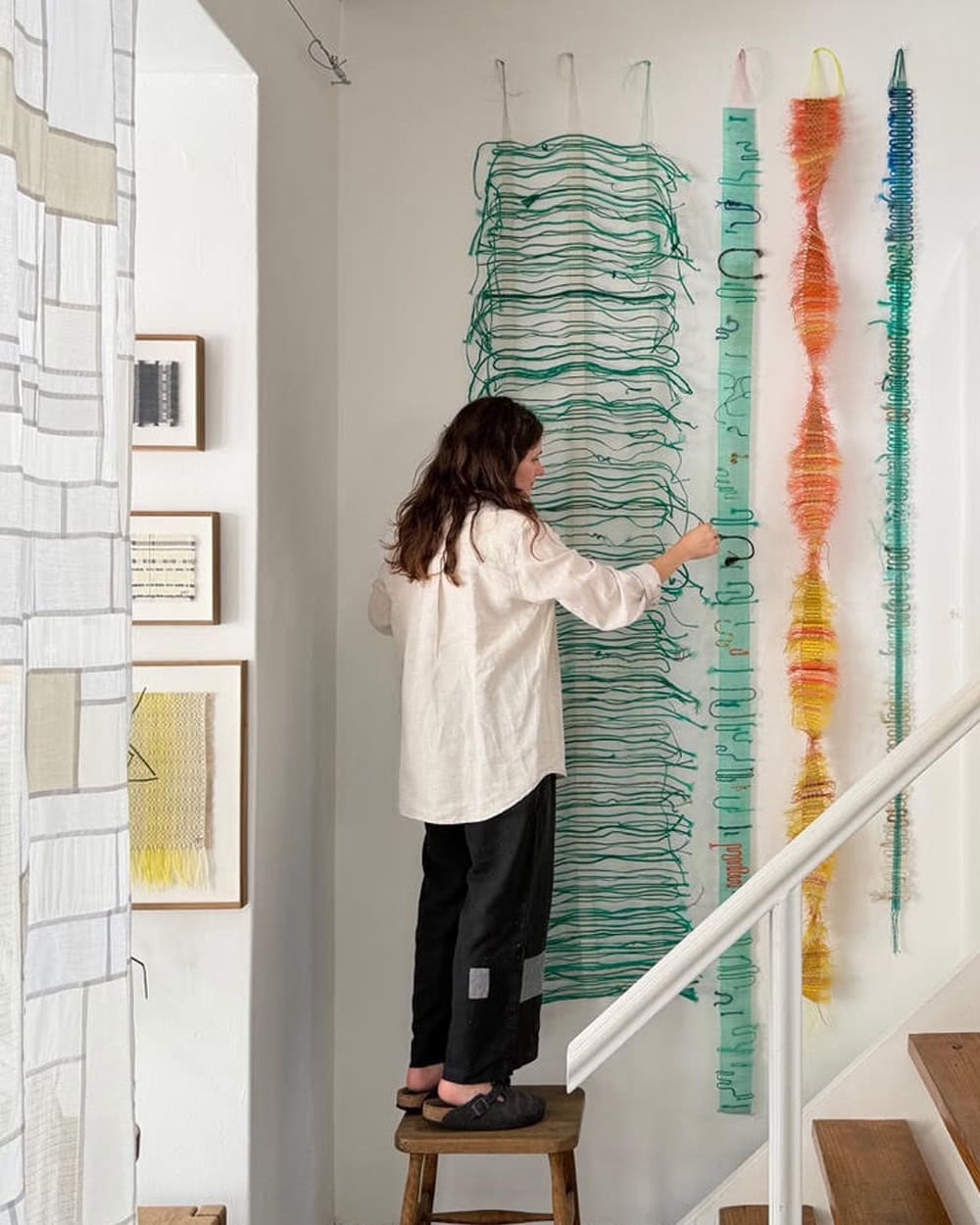 Lucie Visibly Mending for Mungo in her studio.